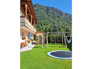 a playground in a yard next to a house at Dürnberger in St Martin in Scheffsnoth +8 photos