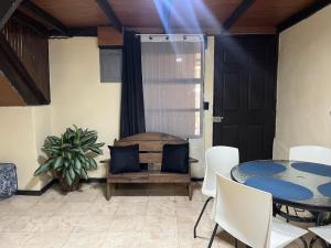 a dining room with a table and white chairs at Rincón del río B&B in Ángeles +14 photos