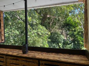 a window in a room with a view of trees at Rincón del río B&B in Ángeles