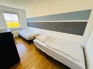 a room with two beds and a window at FeWo Einetal 3 im schönen Ostharz in Harzgerode