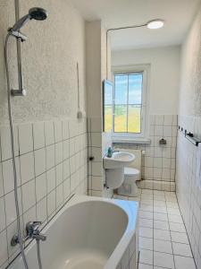 a bathroom with a tub and a toilet and a sink at FeWo Einetal 3 im schönen Ostharz in Harzgerode