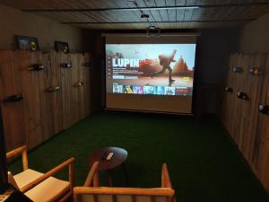 a room with a screen with a movie on it at El Loft de Can Padrosa in Riumors