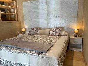 a bedroom with a large bed with two lamps on it at Can Padrosa Mini loft 4 in Riumors +37 photos