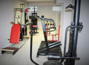 a fitness room with a gym with tread machines at Appart Hotel Corte HR in Corte