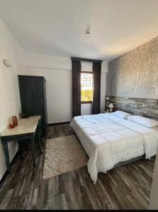 a bedroom with a large bed and a desk at Casa Clara Pool Strand Meerblick in Khlorakas +20 photos