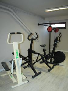 a gym with several exercise equipment in a room at Appart Hotel Corte HR in Corte