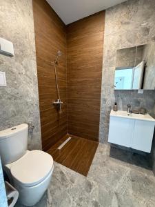 a bathroom with a toilet and a sink at Хостел Дебелт in Debelt