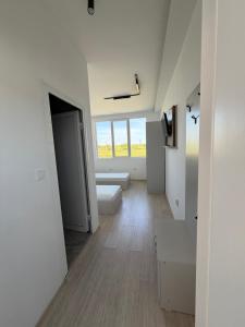 a white room with a bed and a window at Хостел Дебелт in Debelt