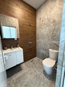 a bathroom with a toilet and a sink at Хостел Дебелт in Debelt