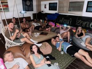a group of people sitting on a couch at The Cabin Backpackers Hostel & Bar in Chiang Mai