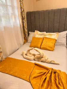 a bed with yellow sheets and a snake on it at Victory homes in Eldoret