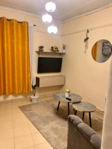 a living room with a tv and a table at Victory homes in Eldoret