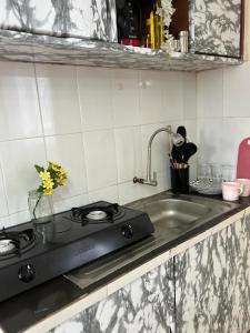 a kitchen counter with a stove and a sink at Victory homes in Eldoret