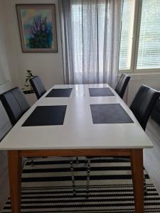 a table in a room with chairs around it at City Apartment Hilla in Rovaniemi