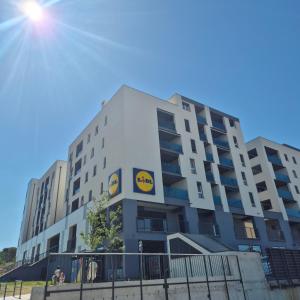 a building with a yellow sign on the side of it at MODERN ESCAPE apartment with garage in Split