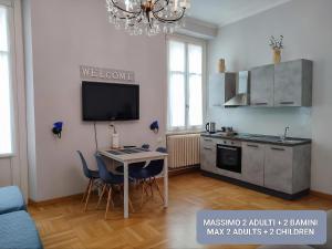 a kitchen with a table and a tv in a room at Villa Scalabrini in Como