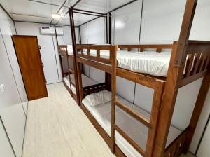 a bedroom with two bunk beds in a room at Wave Hostels Arugam Bay - With Swimming Pool in Arugam Bay