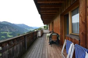 a porch of a house with chairs on it at Edelweiss 104 - Typ B in Fontanella