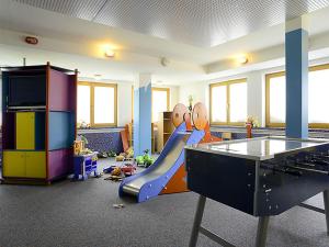 a play room with a slide and a pool table at Edelweiss 104 - Typ B in Fontanella +4 photos