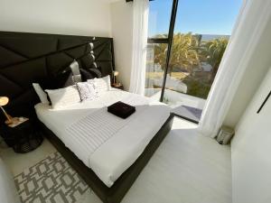 a bedroom with a large bed and a large window at 42 on Kavango Unit 17 in Khomas Region
