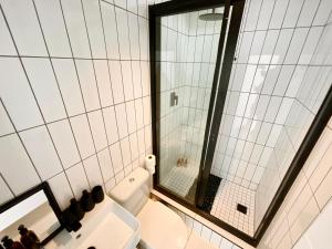 a bathroom with a toilet and a sink and a mirror at 42 on Kavango Unit 17 in Khomas Region +8 photos