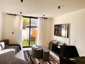 a living room with a couch and a tv at 42 on Kavango Unit 17 in Khomas Region