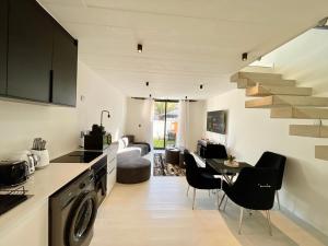 a kitchen and living room with a staircase in a house at 42 on Kavango Unit 17 in Khomas Region