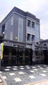 a house with a black gate in front of it at Ciamo Hotel in Ikeja