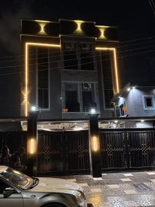 a car parked in front of a building at night at Ciamo Hotel in Ikeja +5 photos