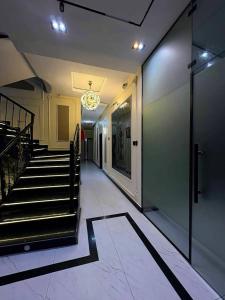 a hallway of a building with stairs and a chandelier at Ciamo Hotel in Ikeja
