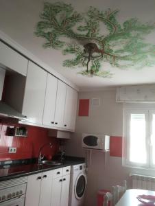 a kitchen with a ceiling with a painting on it at La magia de Benjamín in Oviedo +22 photos