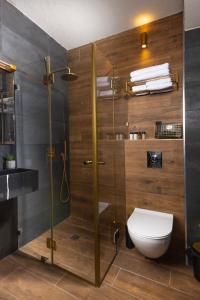a bathroom with a glass shower with a toilet at H34 Boutique Hotel & Spa by the sea of Nahariya in Nahariyya