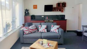 a living room with a couch and a table at Nice Apartment mit Balkon in Glauburg in Glauburg