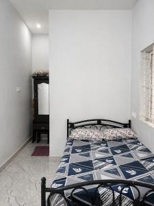 a bedroom with a bed in a room with a tv at D stays in Alāndurai