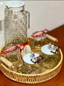 a wicker basket with two glass jars on a table at Mahika Guest House Siquijor in San Juan