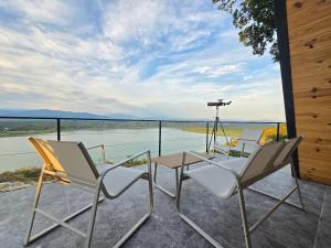 a patio with chairs and a table and a camera at The Quiet Wild in Briska Gora