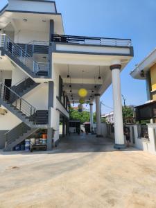 a large white building with stairs and a yellow ball at Hotel O Rosegold Garden in Kuantan