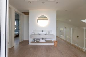 a white bathroom with a sink and a mirror at RYOAN Ichinomiya in Ichinomiya +56 photos