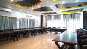 a conference room with long tables and chairs at Jowar Hotel & Resort in Digha +68 photos