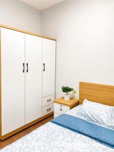 a bedroom with white cabinets and a bed at Cara River Park in Cái Răng