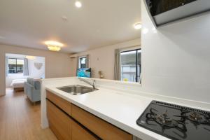 a kitchen with a sink and a stove at 北谷町港2 in Chatan +64 photos