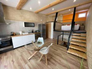 a kitchen with a room with a bunk bed at Can Padrosa Mini Loft 1 in Riumors
