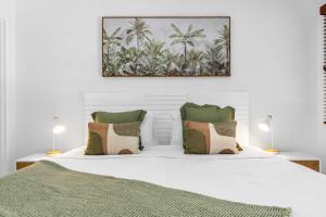 a bedroom with a white bed with two lamps at Laguna Edge - Swim-Out Studio, near Sea & Dining in Trinity Beach +35 photos