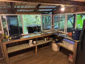 a kitchen with a counter with windows in a room at Donde Sergio - Acantilados in Buenaventura