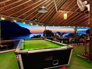 a pool table in a room with a view of the ocean at Phi Phi Sea Sky Resort in Phi Phi Islands