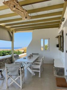 a dining room with a table and chairs at Paros Sunset Villas PSV & PSV2 in Parikia