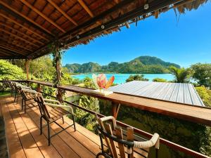 a deck with chairs and a view of the water at Phi Phi Sea Sky Resort in Phi Phi Islands