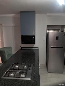 a kitchen with a stove and a stainless steel refrigerator at Beautiful Lagoon House in Blythedale +31 photos
