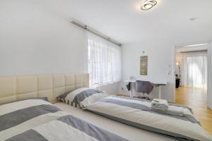 a bedroom with two beds and a desk at Apartment Dußlingen in Dußlingen