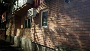 a brick building with a window on the side of it at Modern Apartment in Arad